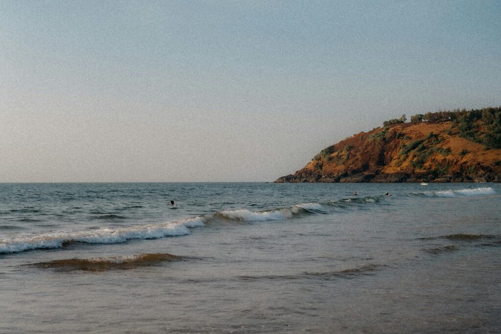 A tranquil scene of waves and coastline at Gokarna's scenic Kudle Beach.